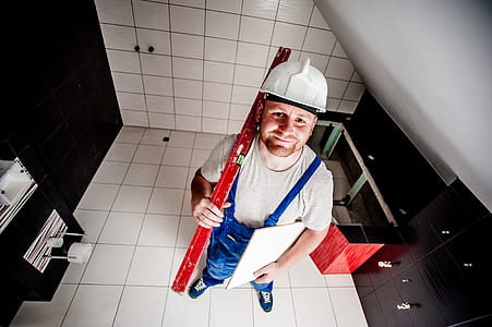 man wearing gray shirt and blue romper with white hardhat thumbnail