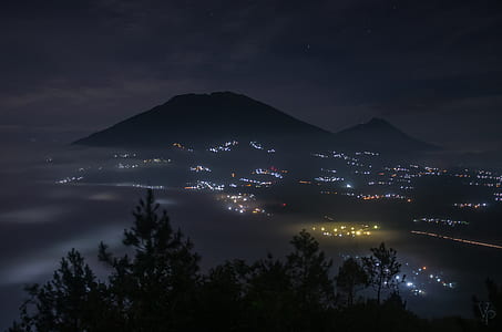 high rise building near mountain during nighttime thumbnail