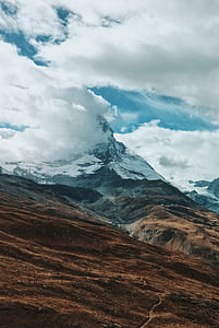 snow capped mountains near field at daytime thumbnail