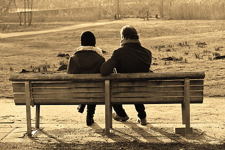two person sitting on wooden bench thumbnail