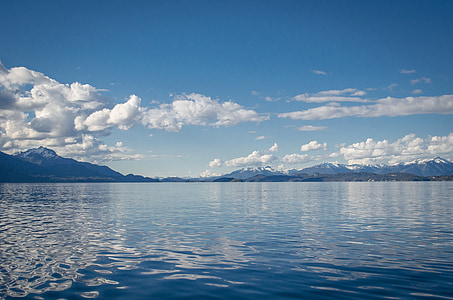 body of water and mountains photo at daytime thumbnail