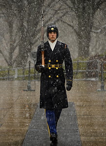 man wearing a black coat and holding a brown rifle thumbnail
