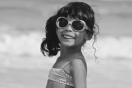 grayscale view of girl wearing sunglasses on shore thumbnail