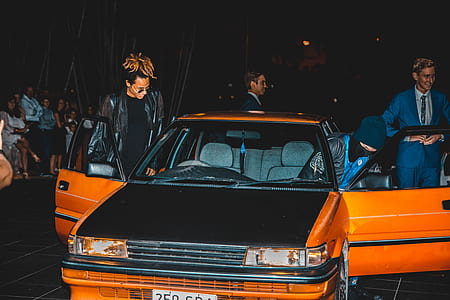 man in black jacket about to sit in car thumbnail