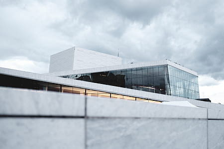 white concrete building under white clouds thumbnail