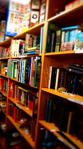 Books in Brown Wooden Shelf Indoors thumbnail