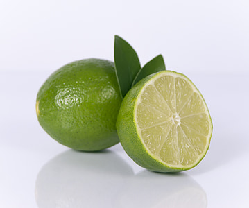 whole and slice of green limes thumbnail