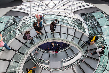 Various people using the helical walkway at City Hall in London. City Hall is the headquarters of the Greater London Authority (GLA), which comprises the Mayor of London and the London Assembly. Situated in Southwark, on the south bank of the River Thames. It was created by Norman Foster and opened in July 2002, two years after the Greater London Authority was created thumbnail