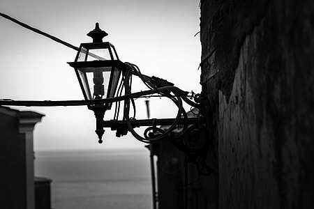 grayscale photography of sconce beside building thumbnail