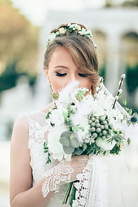 closed-up photo of bride smelling bouquet thumbnail
