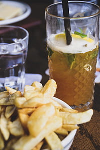 clear highball glass filled with brown liquid thumbnail