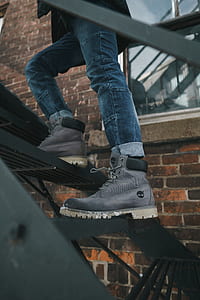 person walking up black metal building emergency stairs thumbnail