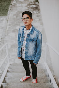 man standing on grey concrete stair outside thumbnail