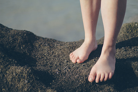 person standing on brown soil near body of water thumbnail