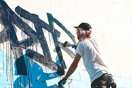 man painting on wall thumbnail