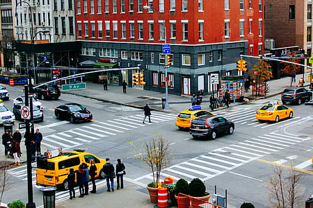 cars passing by buildings during daytime thumbnail
