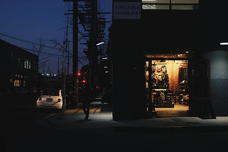 white vehicle parked near building with opened door during nighttime thumbnail