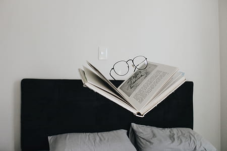 eyeglasses on top of hardbound book thumbnail
