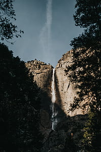 gray rock mountains with waterfalls under gray sky at daytime thumbnail