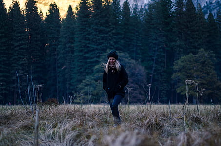 woman walking on grass field thumbnail