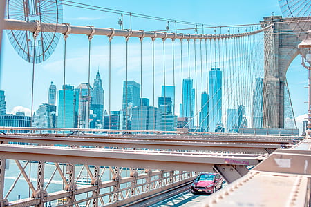 aerial view photo of red vehicle on suspension bridge thumbnail