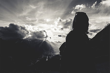 silhouette photograph of woman with clouds on background thumbnail