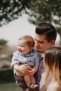 man carrying baby boy thumbnail