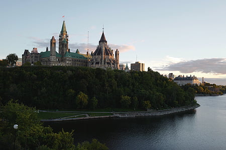 beige and teal castle near body of water thumbnail
