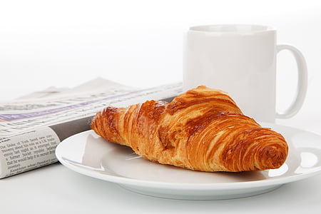 French bread on white ceramic plate beside white ceramic mug thumbnail