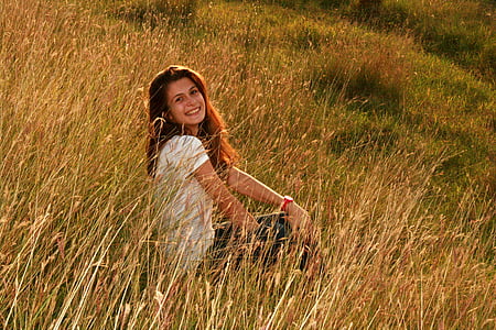 woman wearing white shirt sitting on grass thumbnail