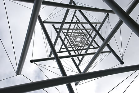 low angle photography of gray metal utility tower under white sky at daytime thumbnail