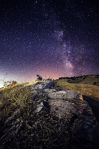 beige grass covered mountain under purple sky ay nighttime thumbnail
