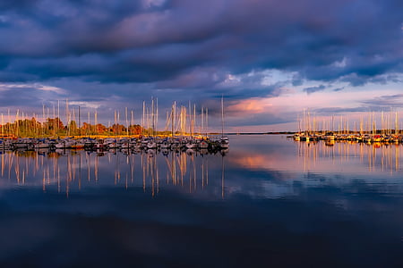 boats under gray cloudy sky thumbnail