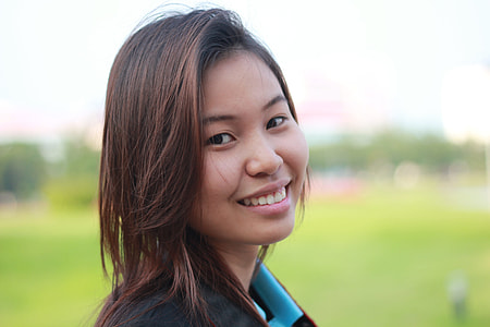 woman smiling near grass thumbnail