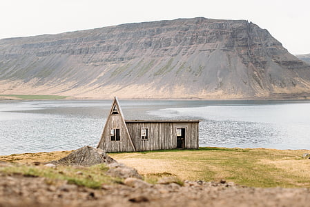 brown wooden house near body of water thumbnail