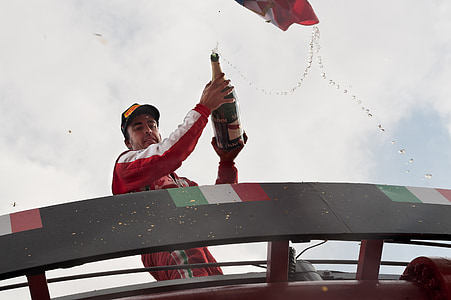 F1 racer pouring wine during daytime thumbnail
