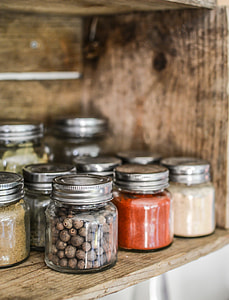 condiment containers on brown wooden rack thumbnail