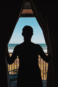 silhouette photo of woman near the window thumbnail