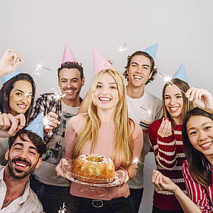 celebrating people in pink and teal party hat thumbnail