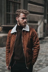 man standing near building looking sideways thumbnail