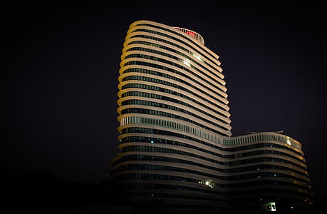 grey concrete building at night thumbnail
