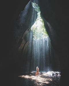 woman with sunlight between rocks thumbnail