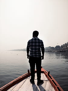 Man Standing On Wooden Boat thumbnail