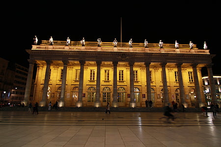 people in front of concrete building during night time thumbnail