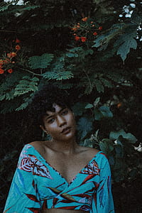 woman standing in front of flowering plant thumbnail