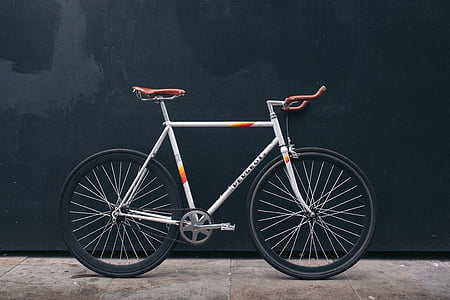 gray and orange road bike parked on black wall thumbnail
