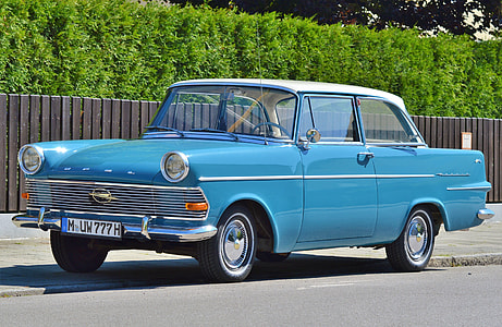 classic blue coupe parked near brown fence thumbnail