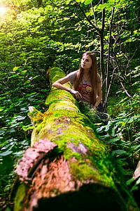 woman beside brown tree branch thumbnail