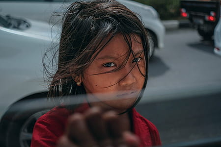 photo of girl about holding vehicle's half-opened window thumbnail