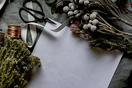 white paper on the table beside the flowers thumbnail